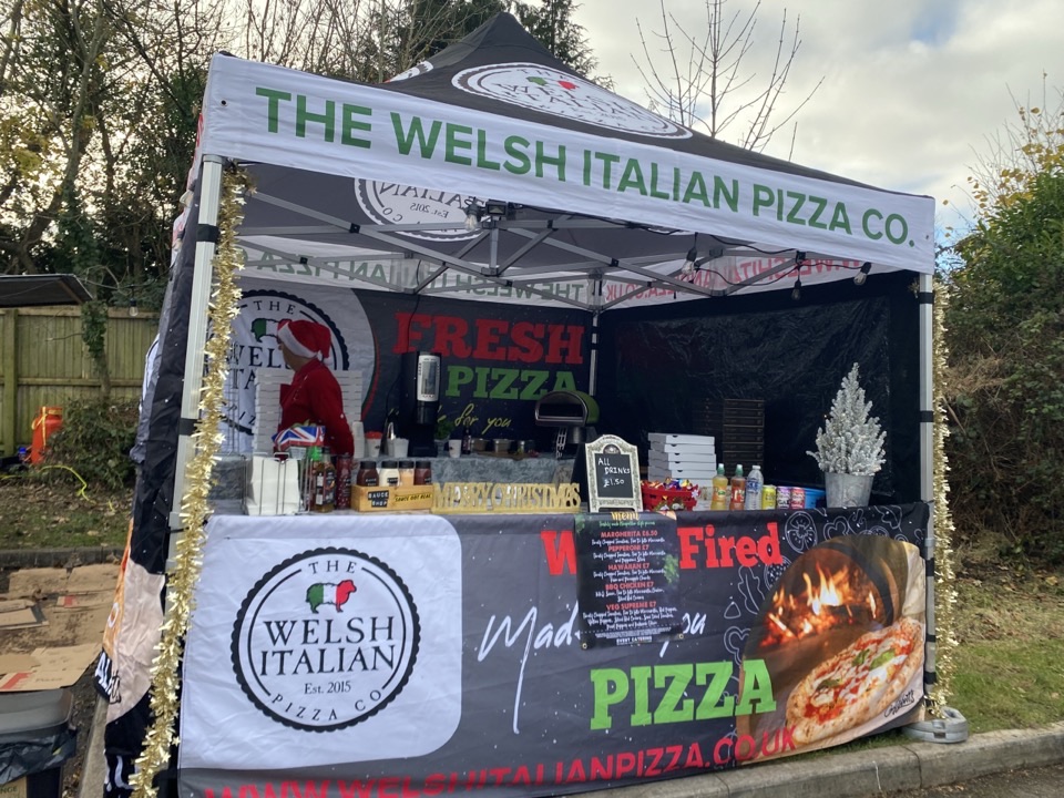 The Welsh Italian Pizza Co festival stall with branded gazebo and oven banners